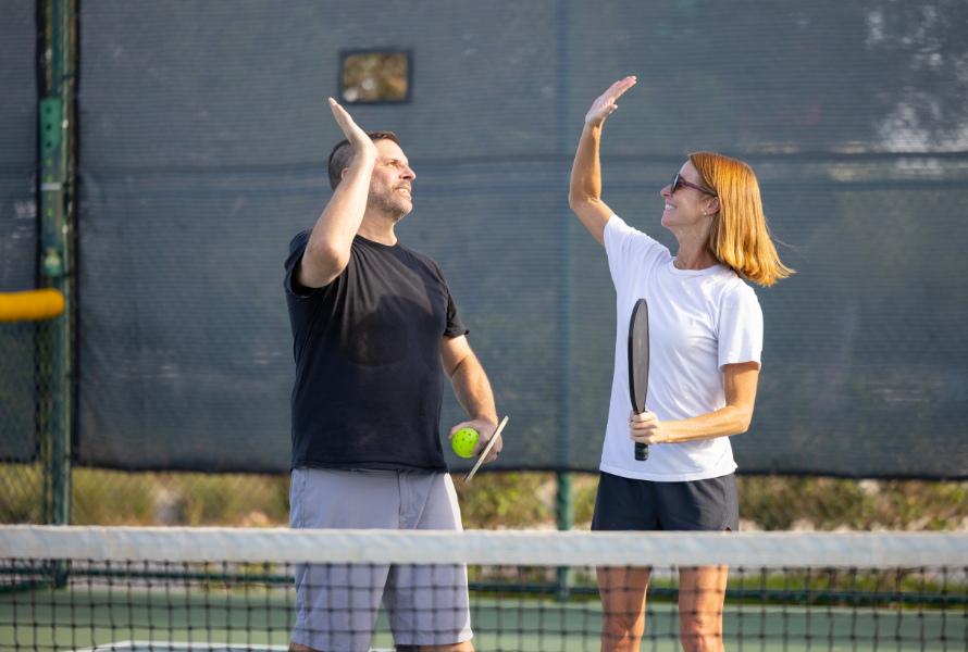 Pickleball player stretching on the court to prevent injuries and enhance performance