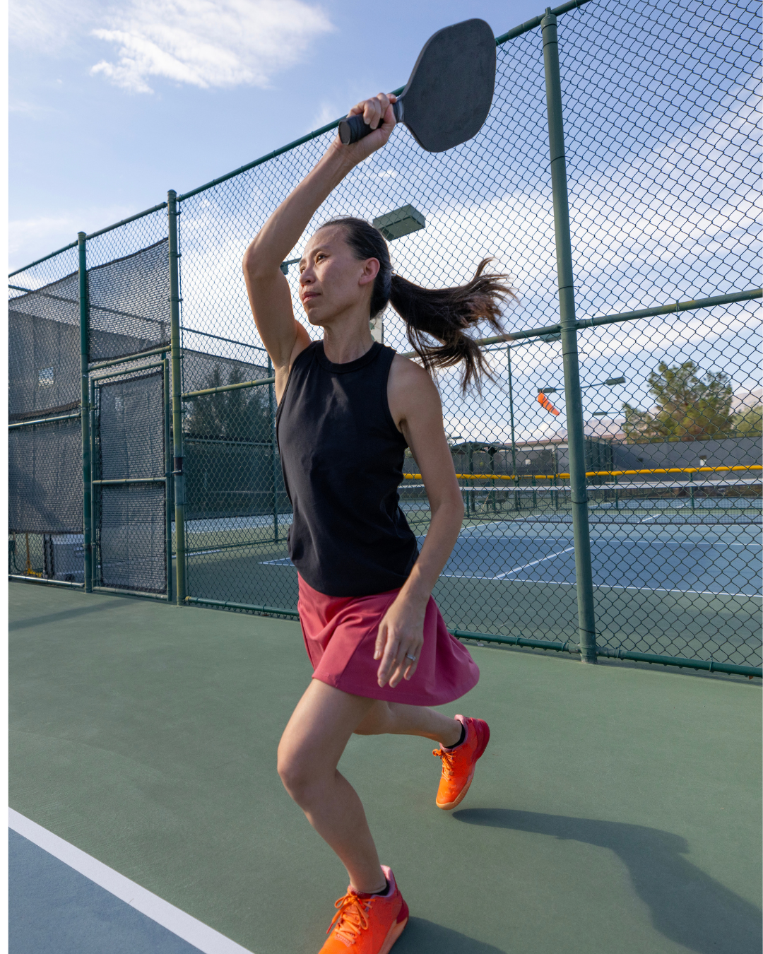 Pickleball player executing an Erne shot mid-air