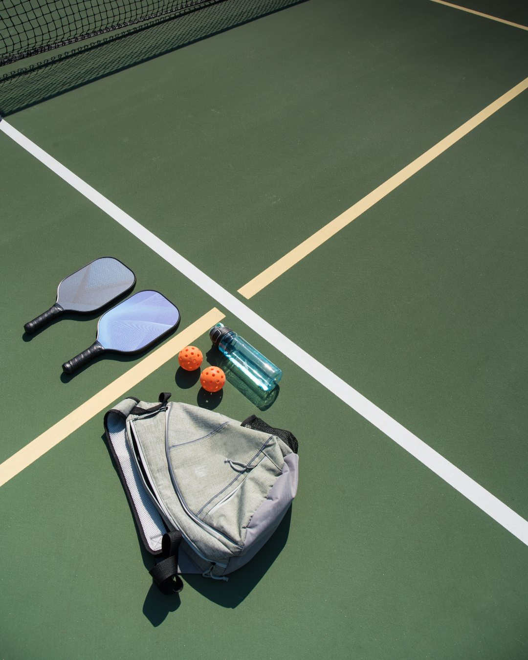 Selection of pickleball equipment including paddles, balls, nets, shoes, and apparel for all playing levels