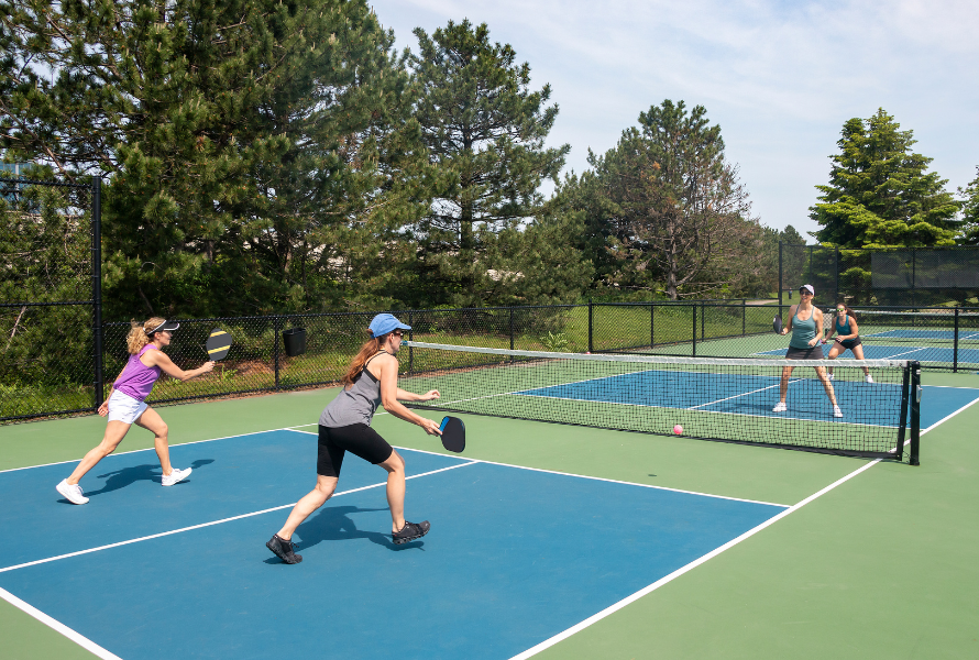 Pickleball player sprinting on the court to improve endurance and match stamina