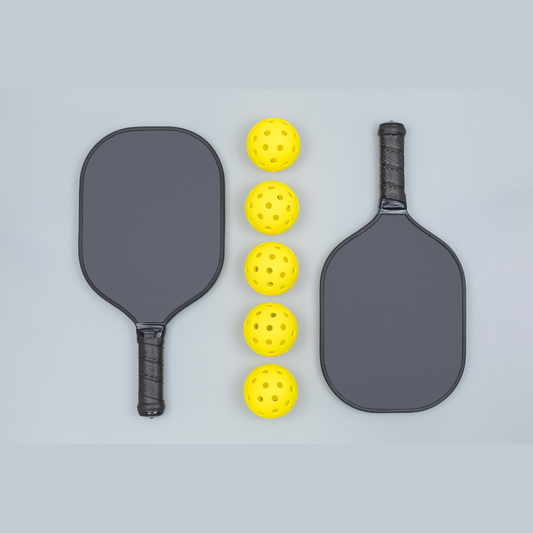 Modern and vintage pickleball paddles and balls displayed side by side