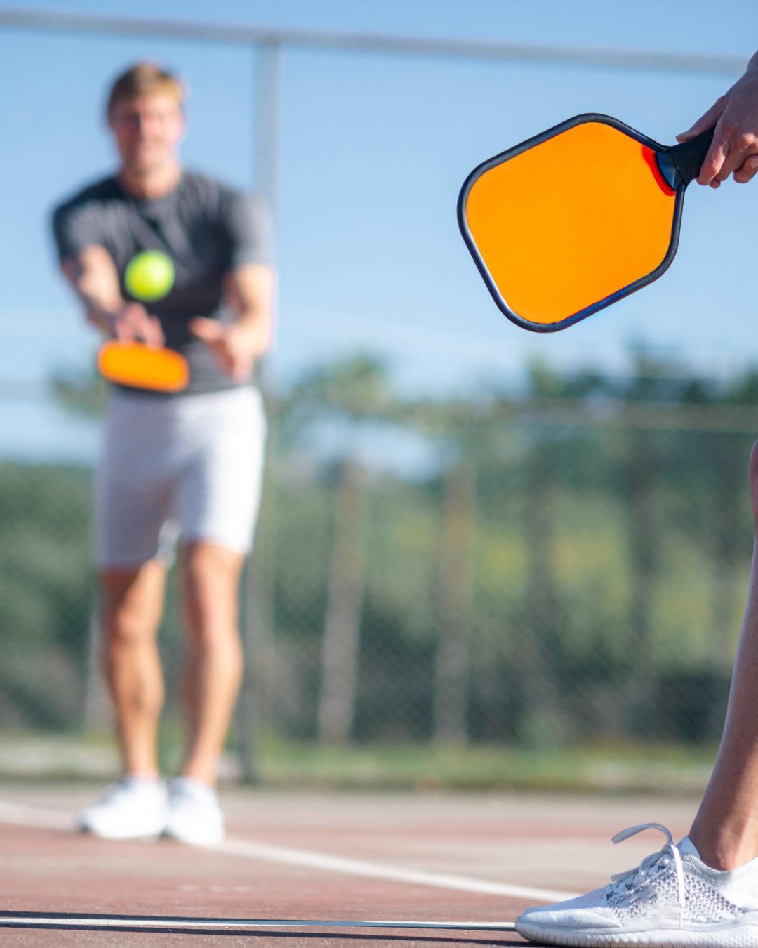 Focused pickleball player preparing for a serve, showcasing strong mental game and concentration